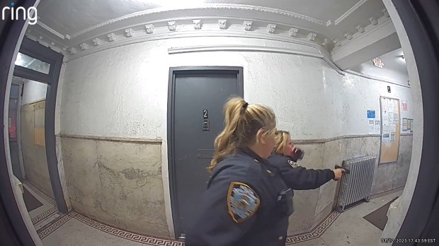 Screengrab from a Ring Camera shows an NYPD officer shooting a man with a knife inside a Bronx apartment building on Jan. 12, 2025. (Obtained by Daily News) 