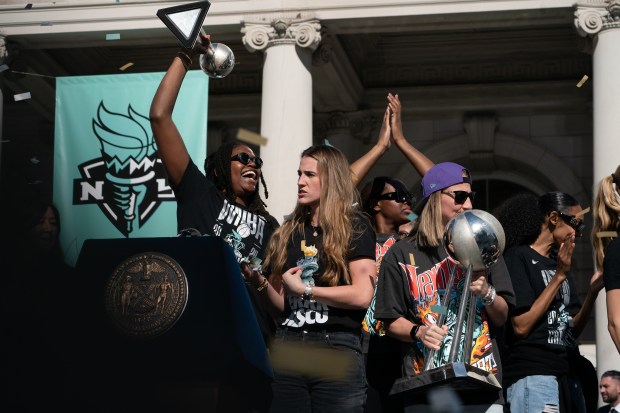 Fans and New York Liberty players celebrate at New York City Hall following a ticker-tape parade in Manhattan's 'Canyon of Heroes' following the Liberty's WNBA Championship win on Thursday, Oct. 22, 2024, in New York City. (Barry Williams for New York Daily News)
