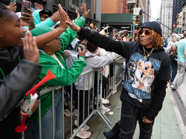 New York Liberty players greet fans after leaving their floats during a ticker-tape parade in Manhattan's 'Canyon of Heroes' on Thursday, Oct. 22, 2024, in Manhattan, New York. (Barry Williams for New York Daily News)