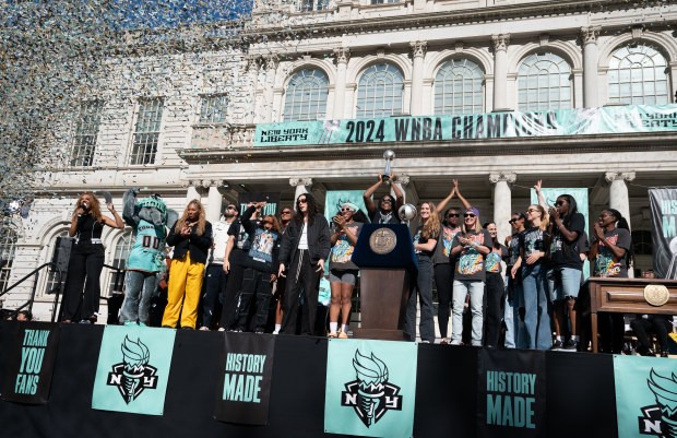 Fans and New York Liberty players celebrate at New York City Hall following a ticker-tape parade in Manhattan's 'Canyon of Heroes' following the Liberty's WNBA Championship win on Thursday, Oct. 22, 2024, in New York City. (Barry Williams for New York Daily News)