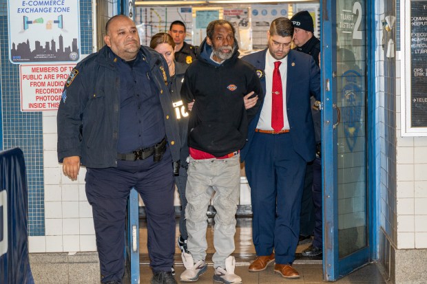 Jamar Banks, 52, is led from the NYPD Transit District 2.