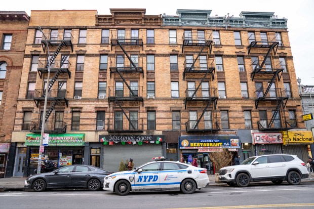 A police vehicle is pictured outside an apartment building on E. 138th St. in the Bronx on Sunday, Jan. 12, 2025, after a woman allegedly stabbed her boyfriend to death in their fifth-floor apartment. (Theodore Parisienne / New York Daily News)