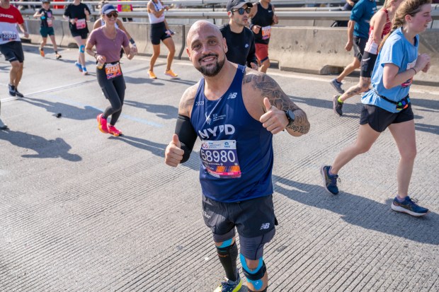 (NYPD Detective Tony Passaro) Views of the New York City TCS Marathon as participants make their way across the Pulaski Bridge in Brooklyn on Sunday November 5, 2023. 1129. (Theodore Parisienne for New York Daily News)