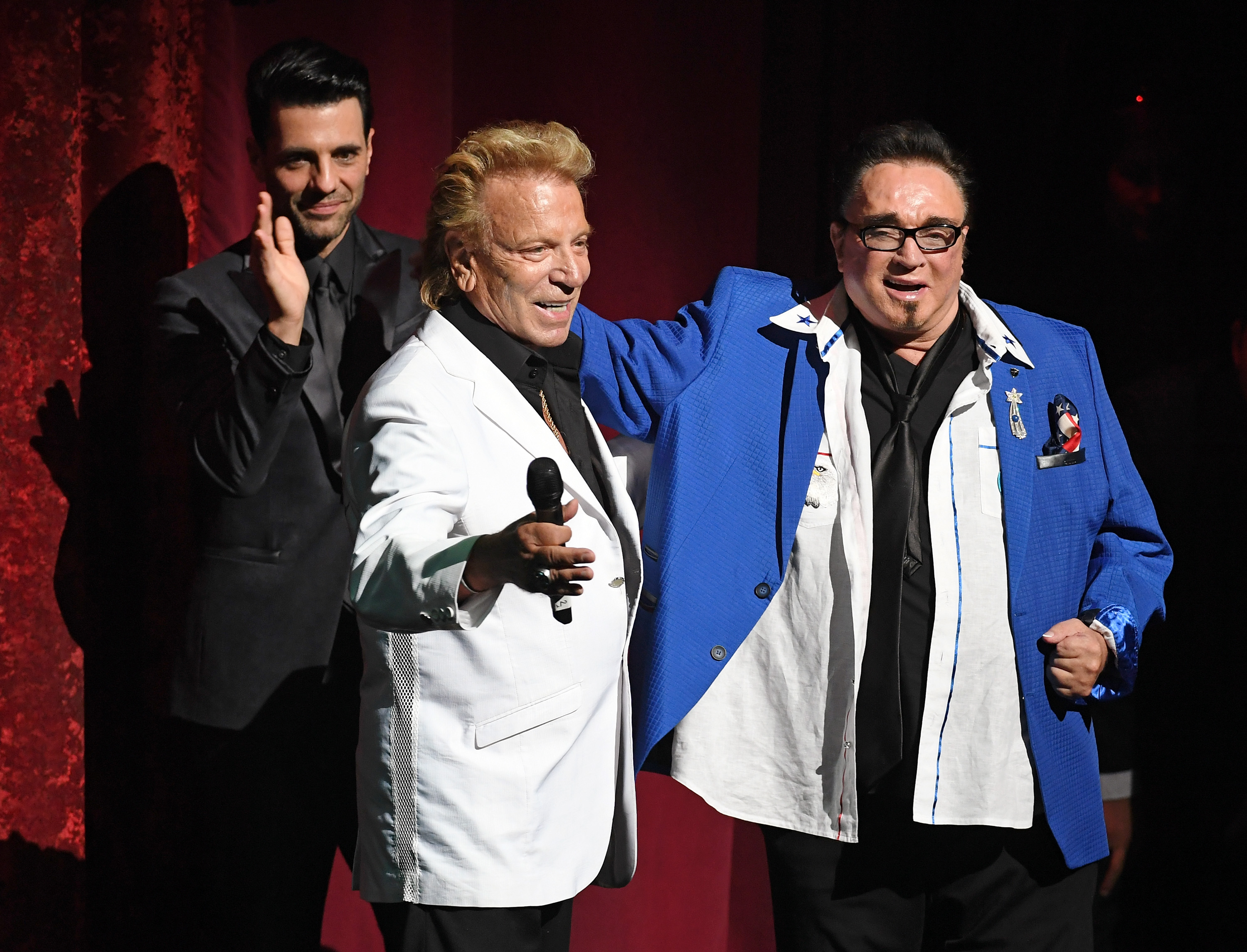 Siegfried Fischbacher, center, and Roy Horn speak during Criss Angel's HELP (Heal Every Life Possible) charity event at the Luxor Hotel and Casino benefiting pediatric cancer research and treatment on Sept. 12, 2016 in Las Vegas, Nevada.