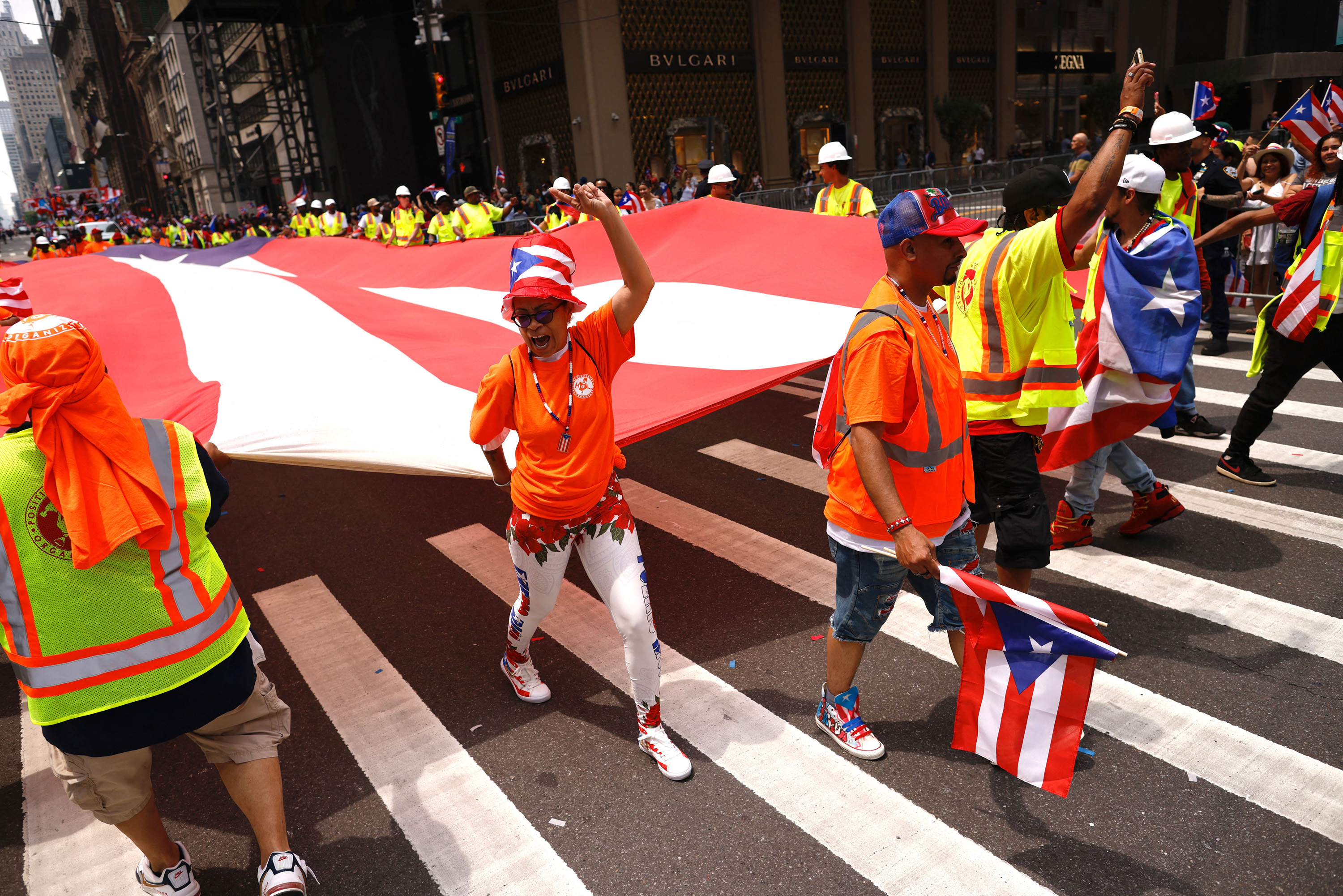 Participants carry a large flag as they march in the 66th annual National Puerto Rican Day Parade in New York City on June 11, 2023.