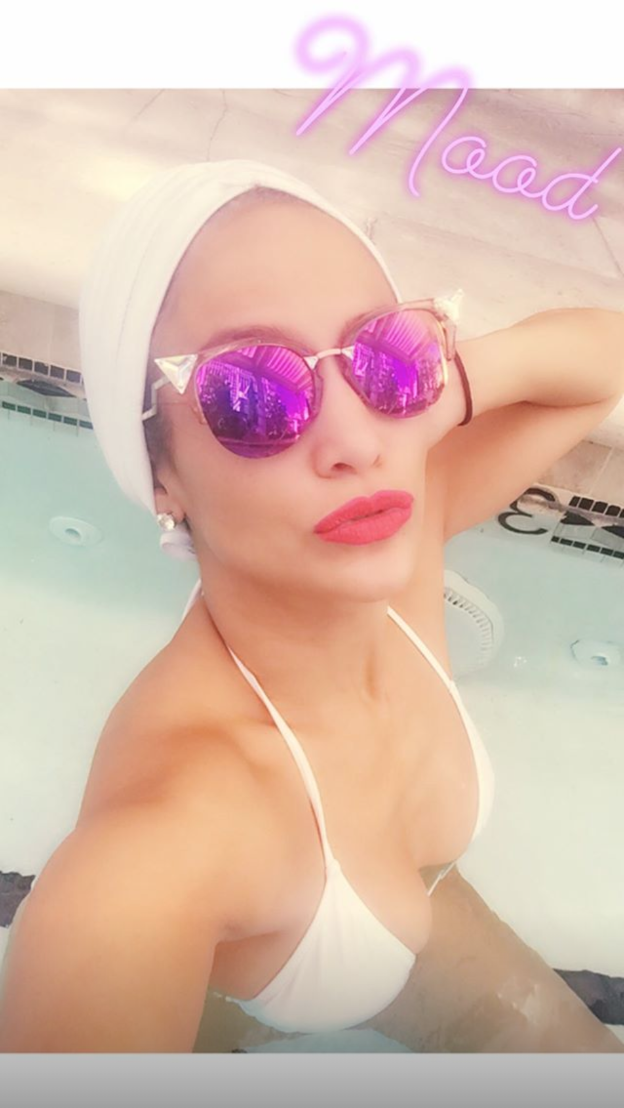 Jennifer Lopez started her long holiday weekend with some pool time. J. Lo takes a selfie in the water wearing red lipstick and a white bikini with the caption: 