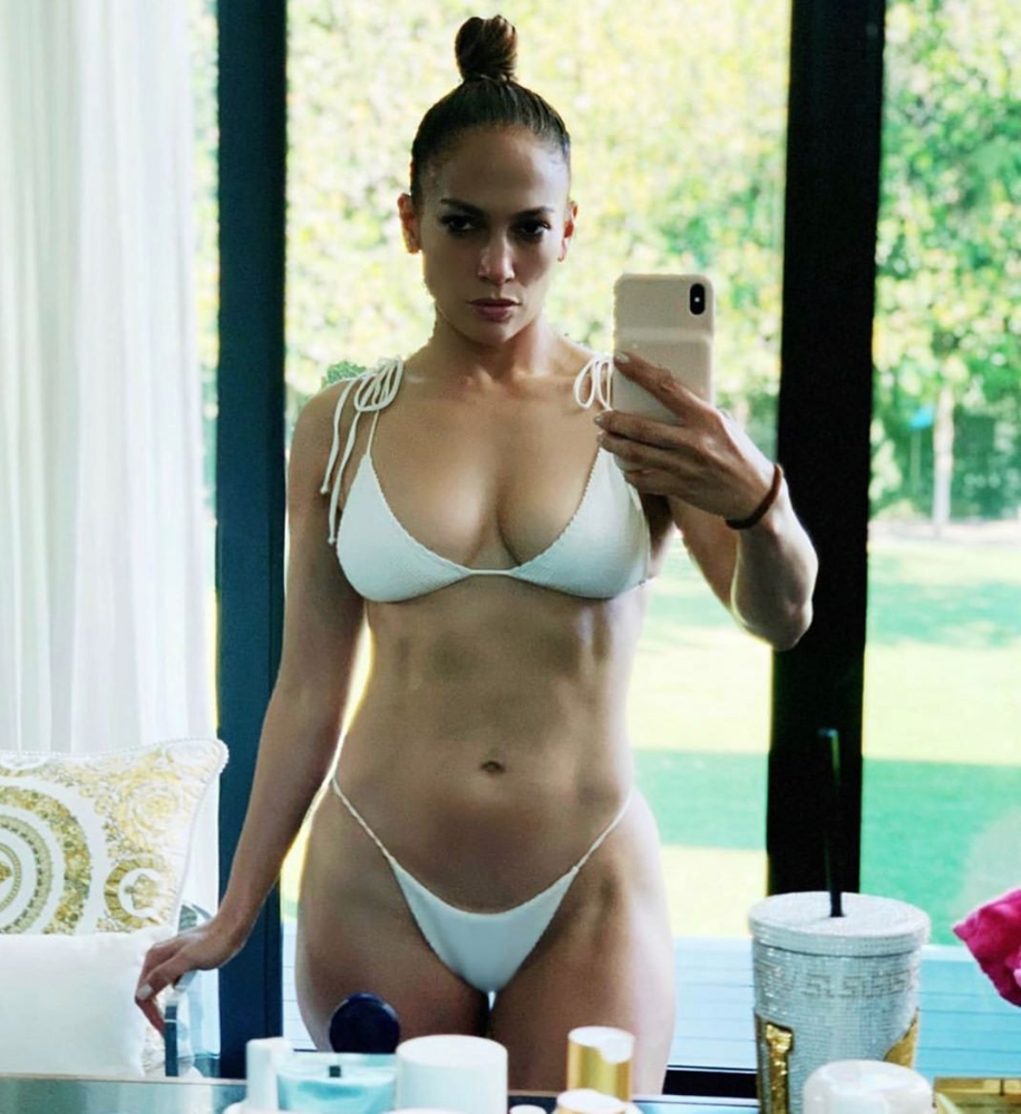 Jennifer Lopez, 50, shows off her six-pack in a string bikini as she feels 